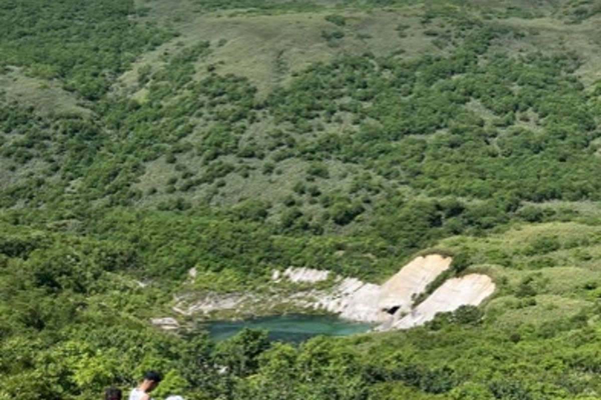 The old mine pond below the green slopes of Iwao-nupuri