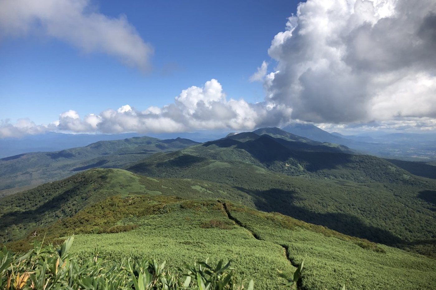The long green ridge above Mekunnai under a wide sky